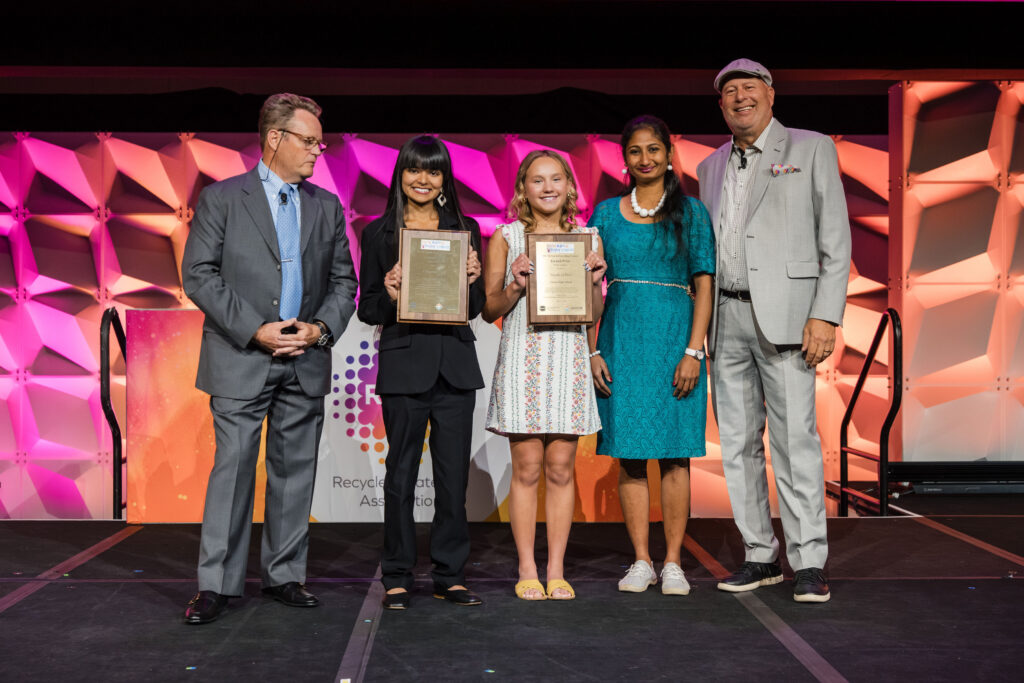 Student video and poster contest winners accept award on stage
