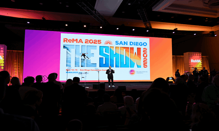 man standing on stage in front of audience